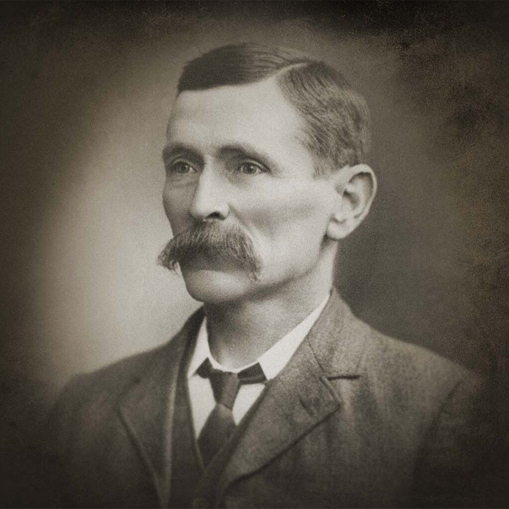 An old, black and white portrait of Frank Hamilton, looking to the left of the image. 