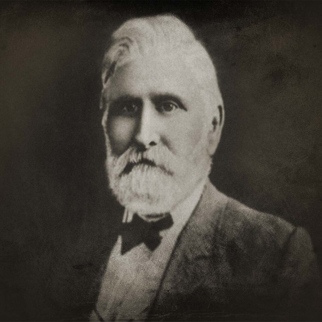 An old, black and white portrait of Henry Hamilton, looking at the camera. 