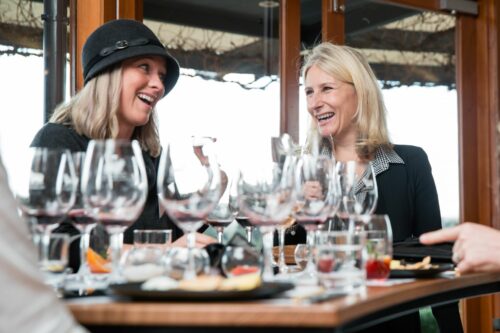 Two women laughing and enjoying Hugh Hamilton wines at the cellar door