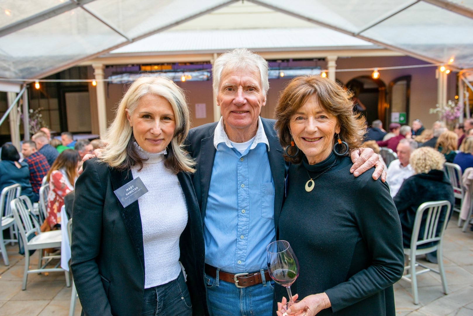 Mary Hamilton and her parents smiling at the camera at a Hugh Hamilton Wines event