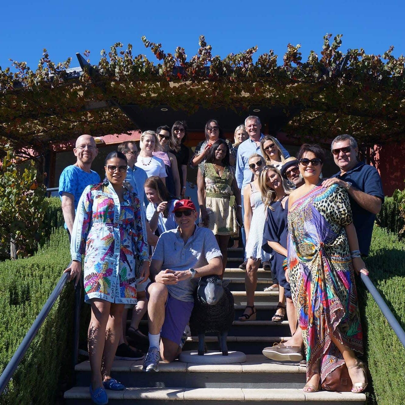Guests standing on the steps of cellar door with the black sheep.